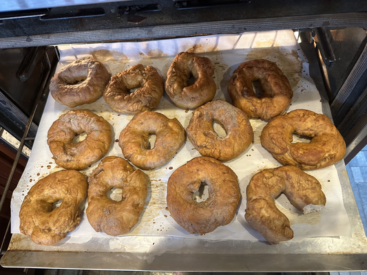 A dozen brownish torus-shaped things on a pan