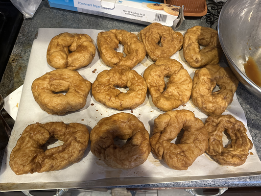A dozen brownish torus-shapped things on a pan