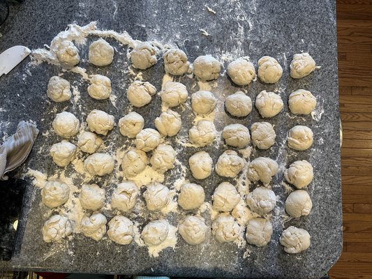 About forty-nine small balls of dough in a grid