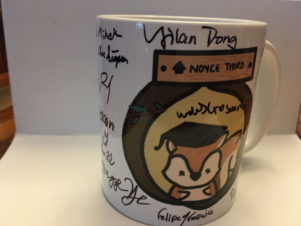 A mug with a picture of a squirrel in a graduation cap and the words 'Noyce 3rd'.  There are multiple signatures.