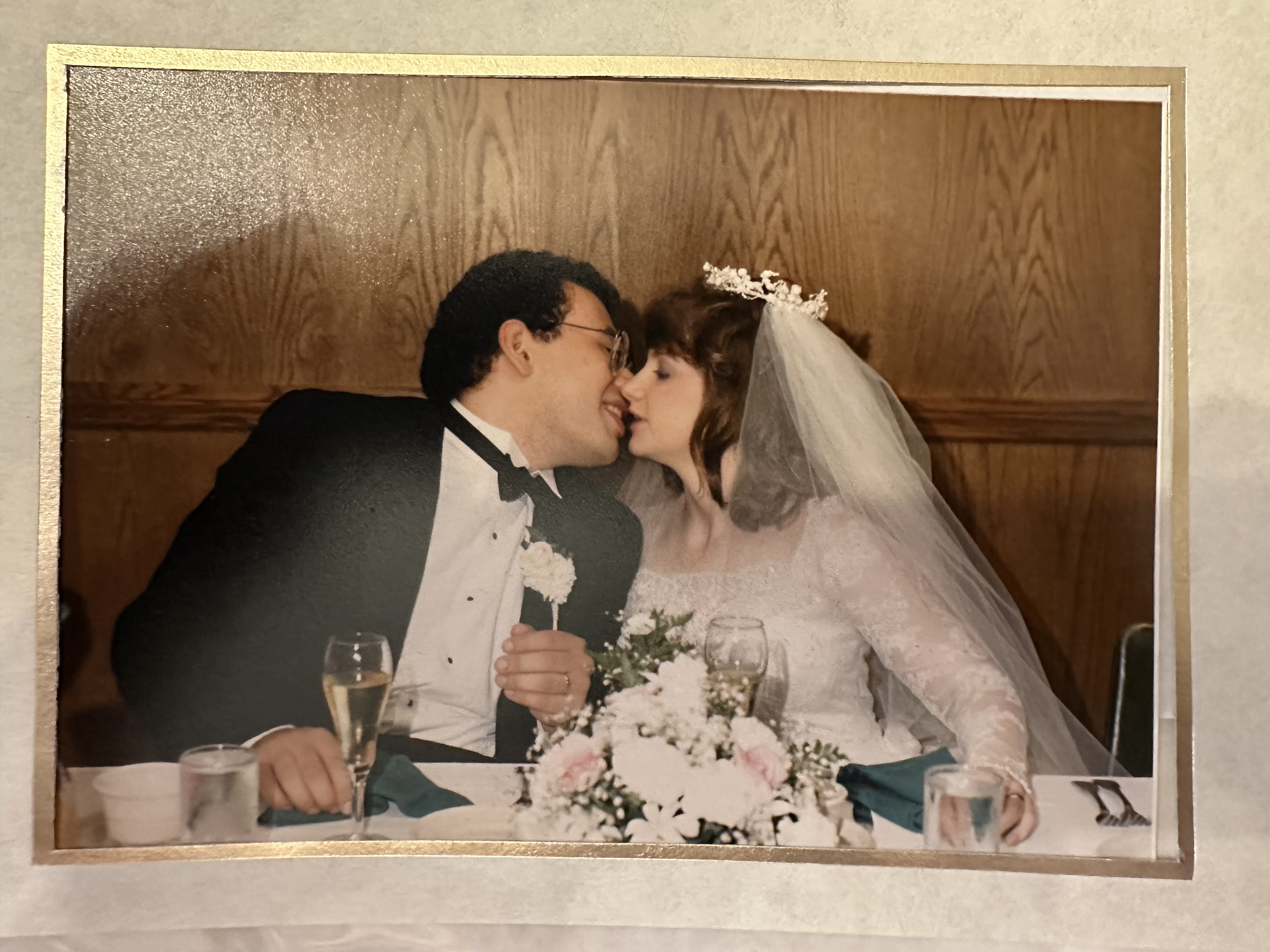 Sam and Michelle kissing at their wedding.